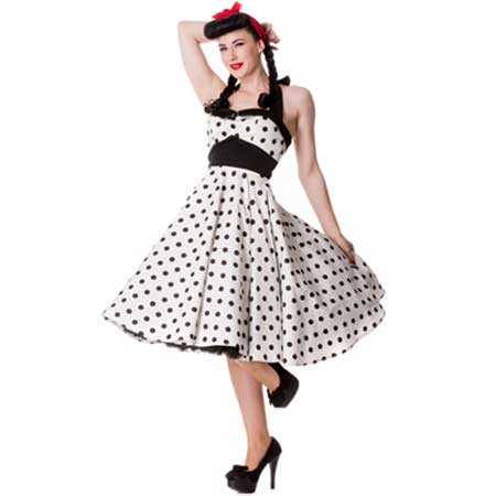 Mulher com vestido branco com bolinhas pretas.