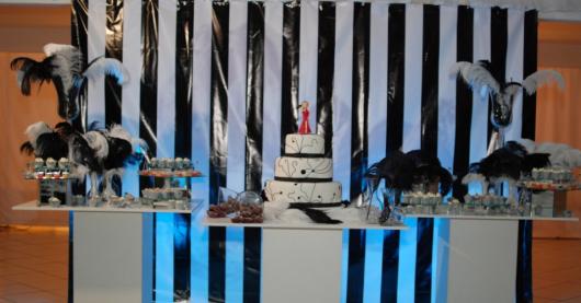 fundo com listras e mesa de bolo com plumas