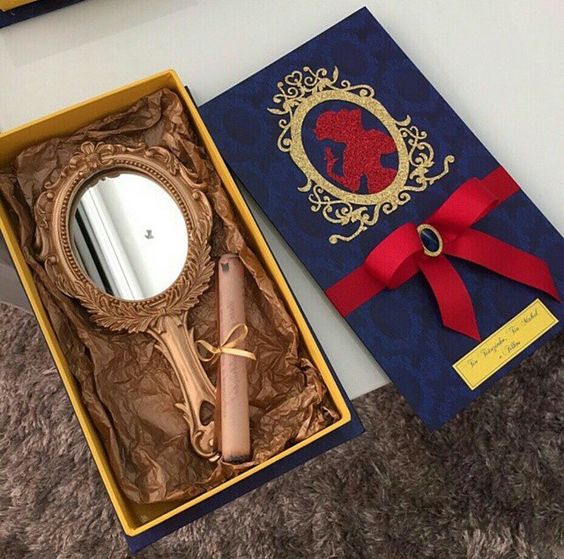 Caixinha azul com pergaminho e espelho.