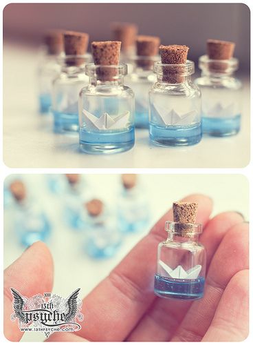 Potinhos de vidro para lembrancinhas com barquinho de papel dentro.