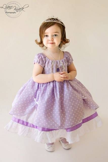 Menina com vestido lilás e branco.