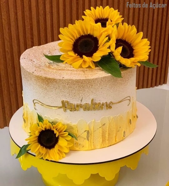 bolo redondo decorado com topo de flores de girassol