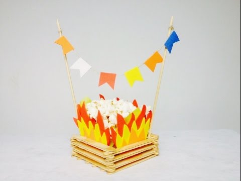 decoração de festa junina simples centro de mesa no formato de fogueira com pipoca