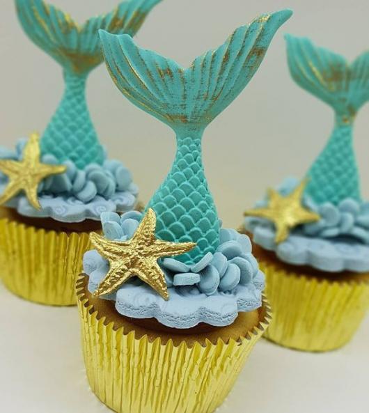 Cupcake com decoração de calda de sereia e estrela do mar.
